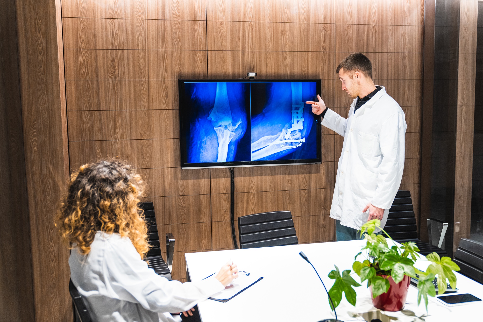 Healthcare Specialists Reviewing Orthopedic X-Ray Images Together