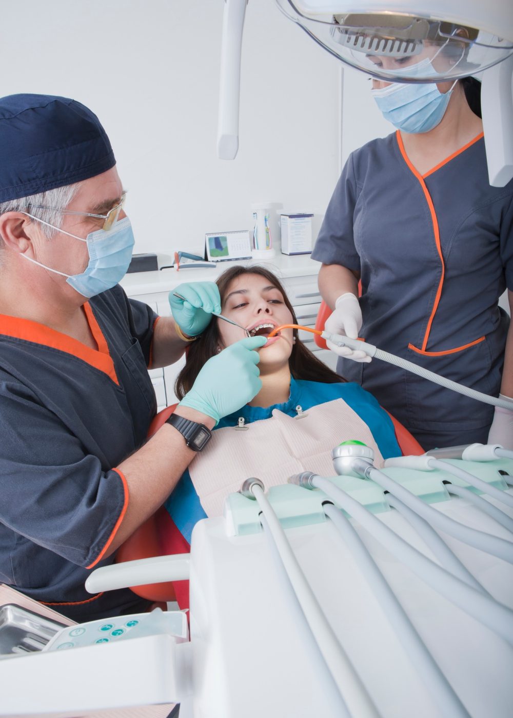 Dentist and dental nurse with patient